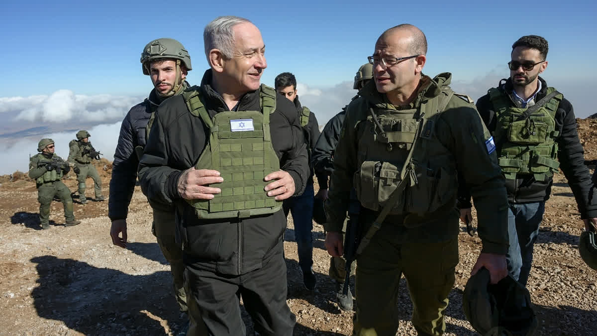 Israel's Prime Minister Benjamin Netanyahu, left, visits Israeli forces in a buffer zone inside Syria, Tuesday, Dec. 17, 2024.