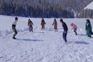 Children play in a snow covered meadow in Gurez, Kashmir