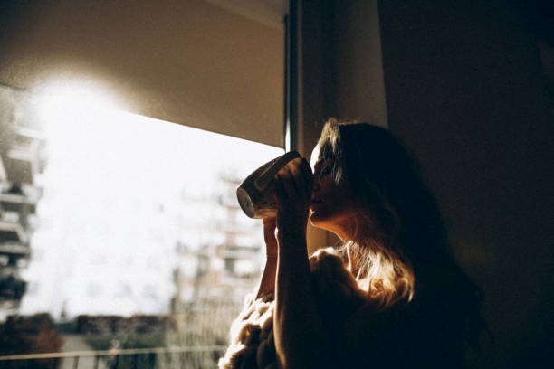 AN YOUNG GIRL DRINKING COFFEE