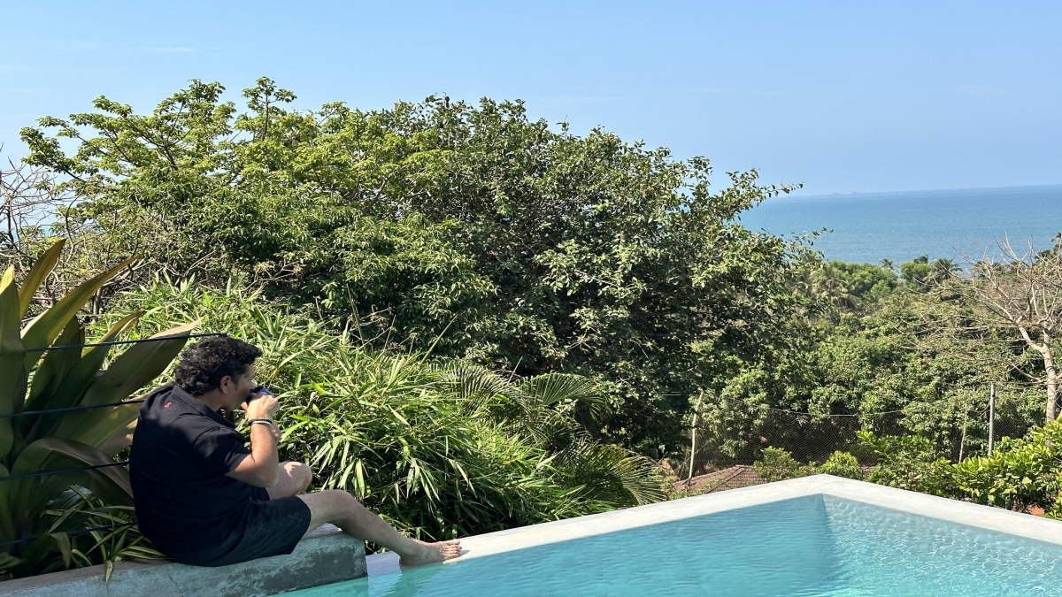 Sachin Tendulkar sitting by swimming pool