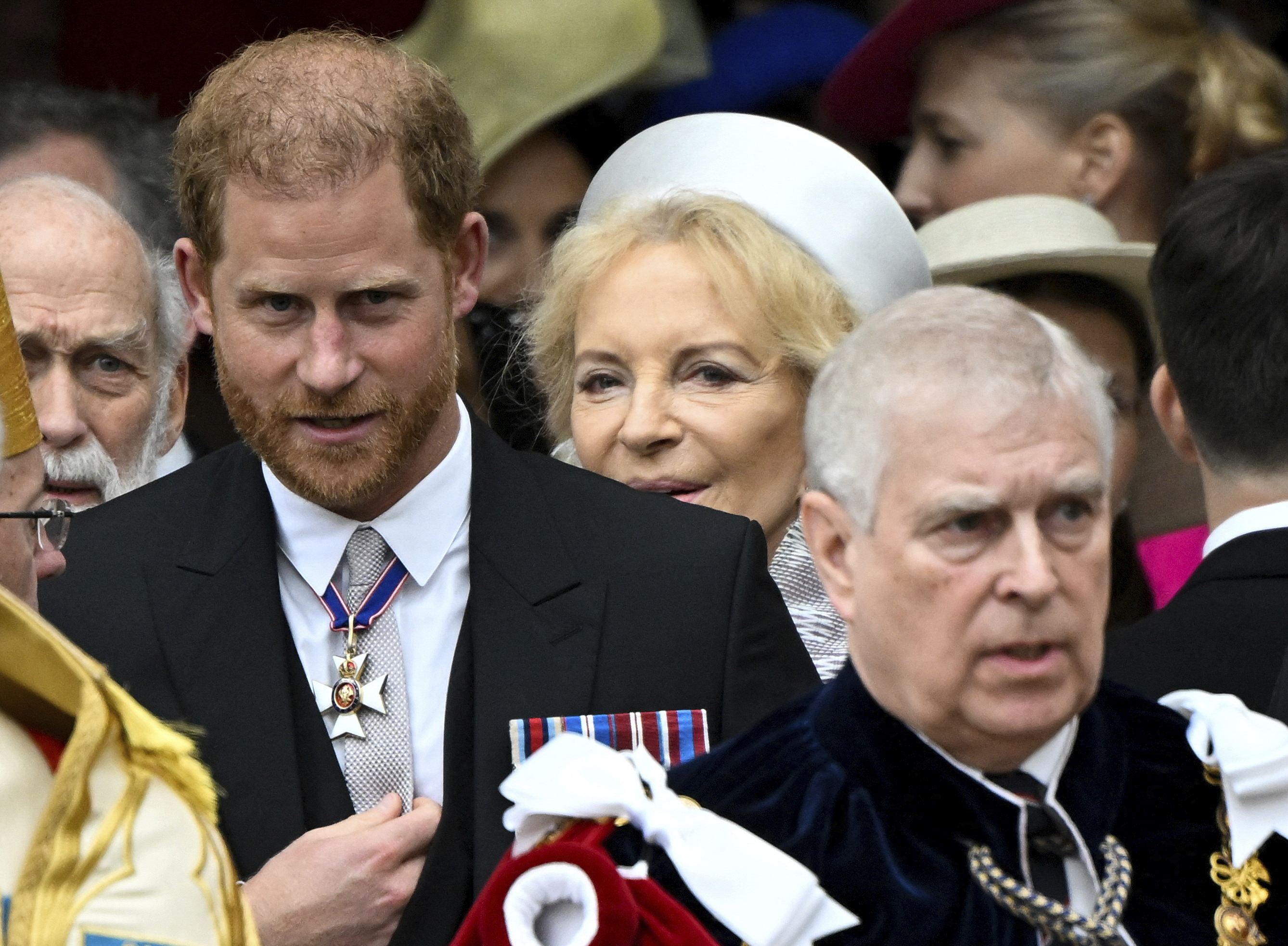 Britain's Prince Harry, Duke of Sussex, and Prince Andrew leave Westminster Abbey following the coronation ceremony of Britain's King Charles and Queen Camilla, in London