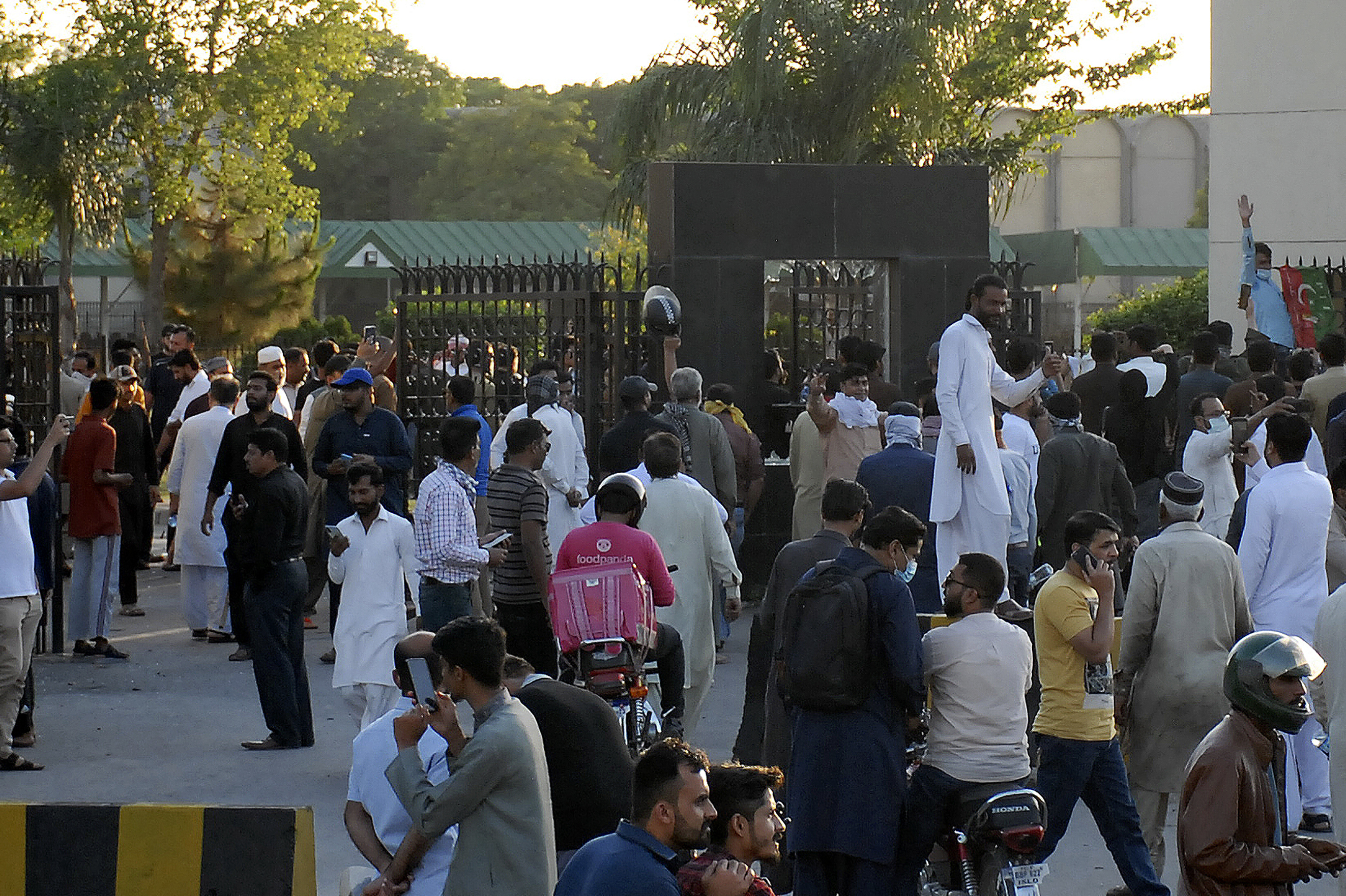 Supporters of Pakistan's former Prime Minister Imran Khan block an entry gate of the Pakistani army's headquarters during a protest protest against the arrest of their leader, in Rawalpindi