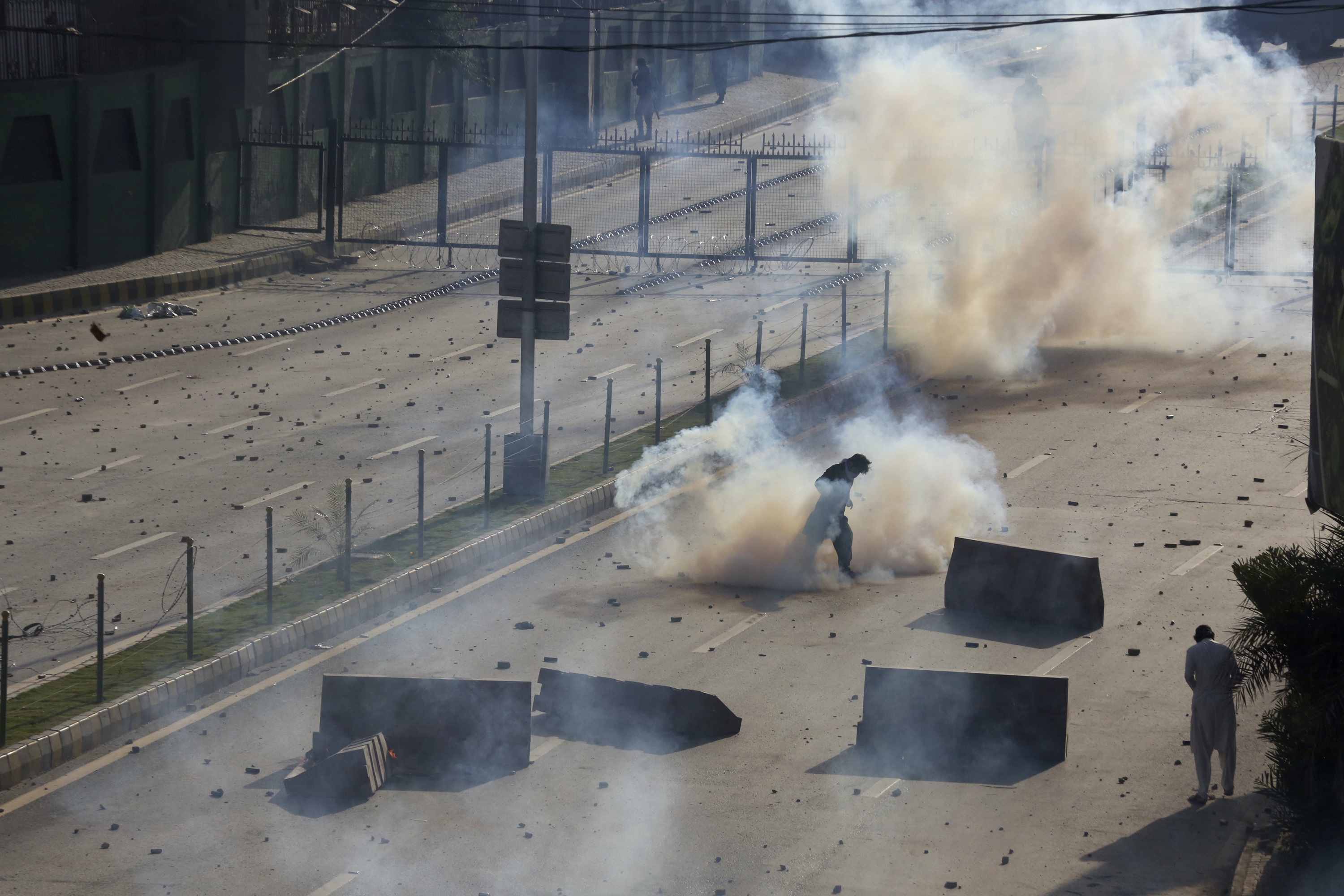 Police fire tear gas to disperse supporters of Pakistan's former Prime Minister Imran Khan protesting against the arrest of their leader, in Peshawar