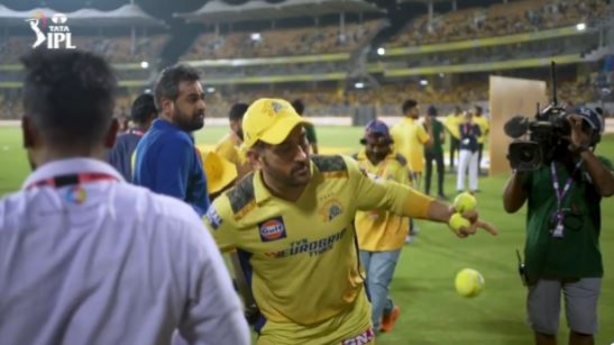 Dhoni throwing the ball towards the fans