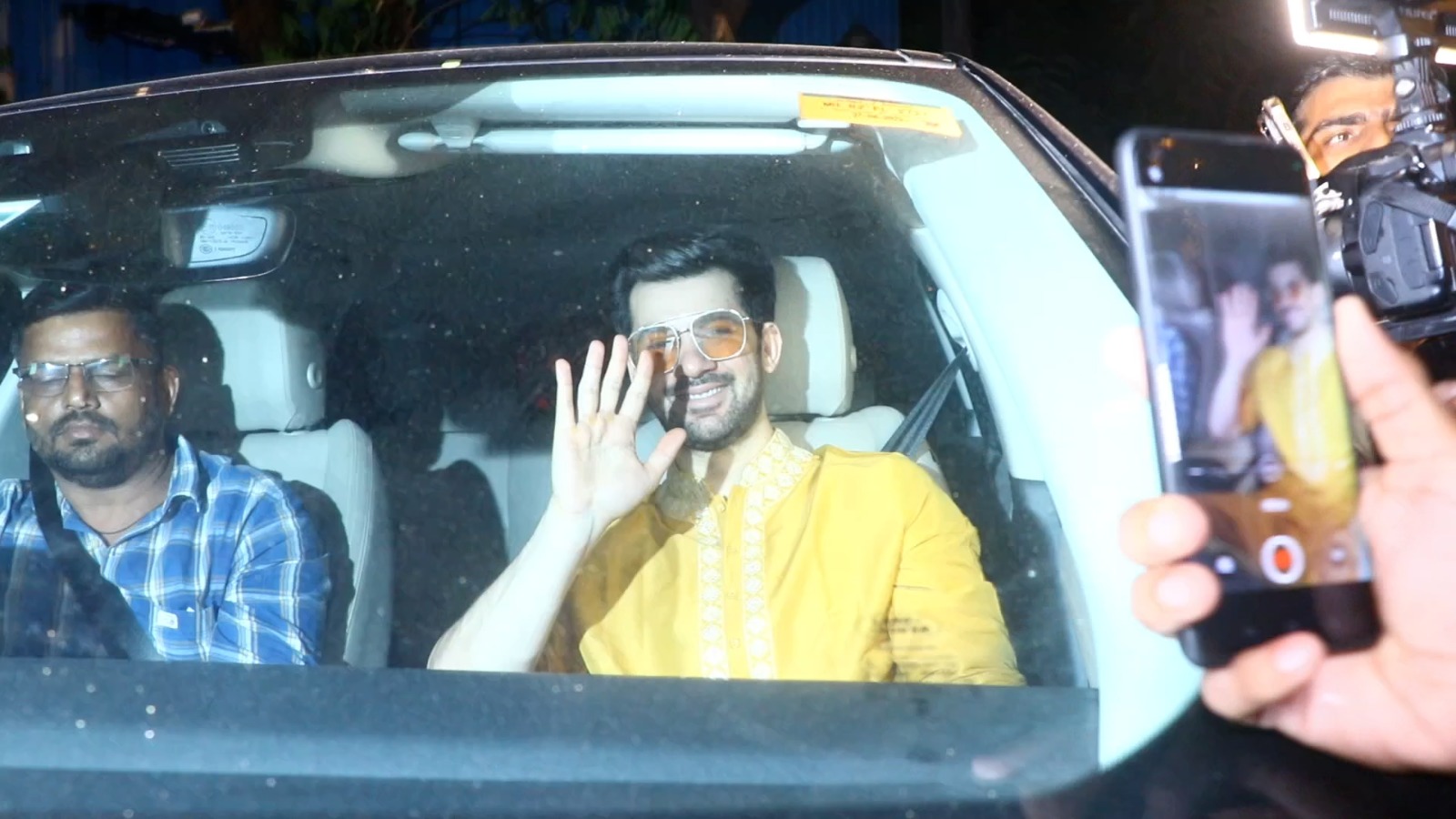 Karan was seen smiling as he arrived in his car wearing a yellow kurta