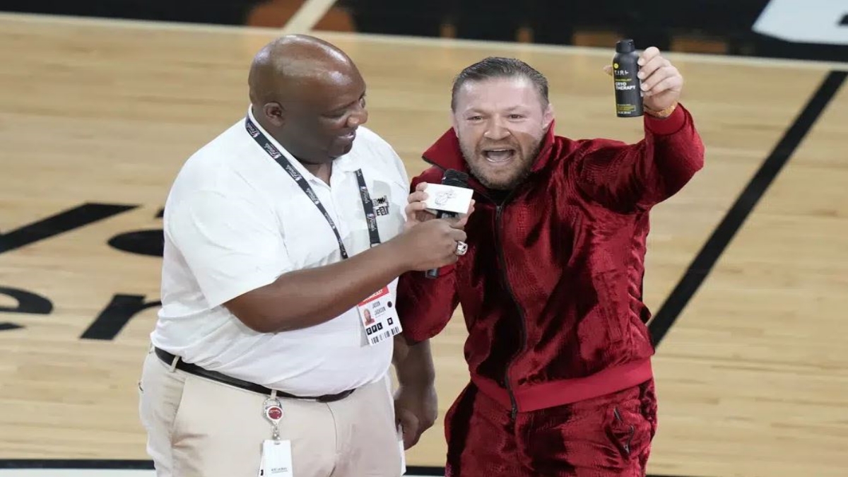 Former UFC champion Conor McGregor promotes a pain-relief spray during a break in Game 4 of the basketball NBA Finals between the Miami Heat and the Denver Nuggets, Friday, June 9, 2023, in Miami.