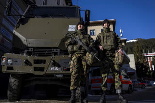 Members of the police stand guard outside the district council chamber during a press conference of police and army regarding security prior to the annual meeting of the World Economic Forum, WEF, in Davos, Switzerland, Friday, Jan. 17, 2025.