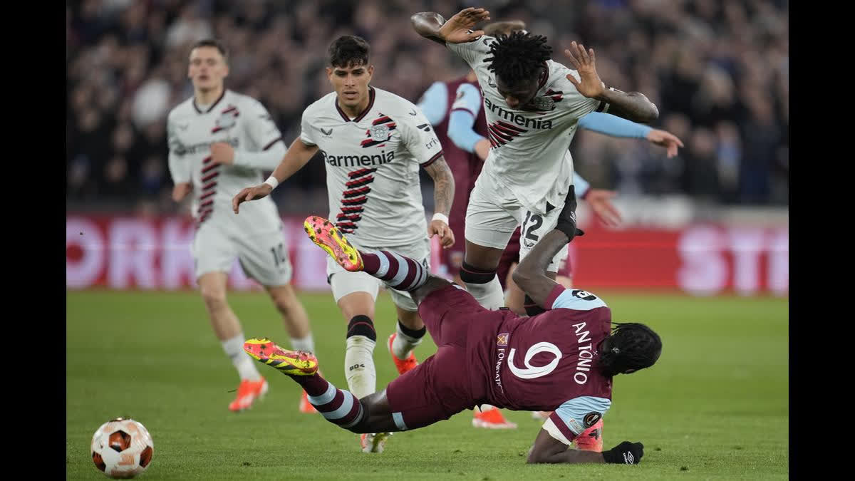 West Ham's Michail Antonio, bottom, is challenged by Leverkusen's Edmond Tapsoba