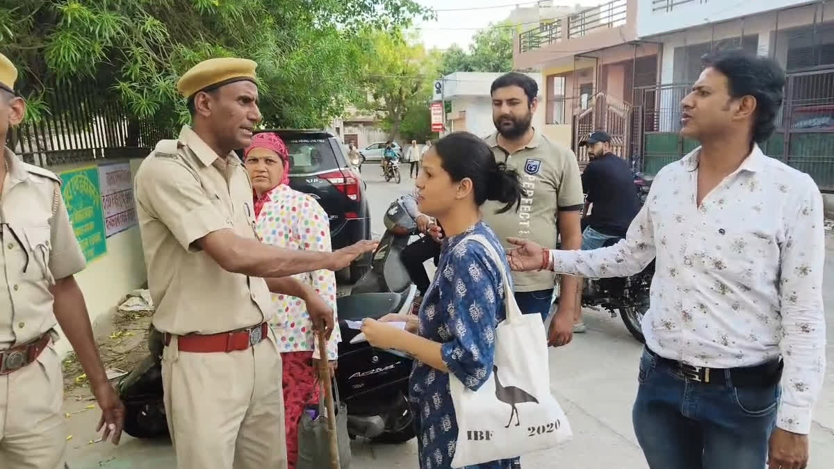 Policemen stopping voters for arriving late outside a polling booth in Jaipur city.