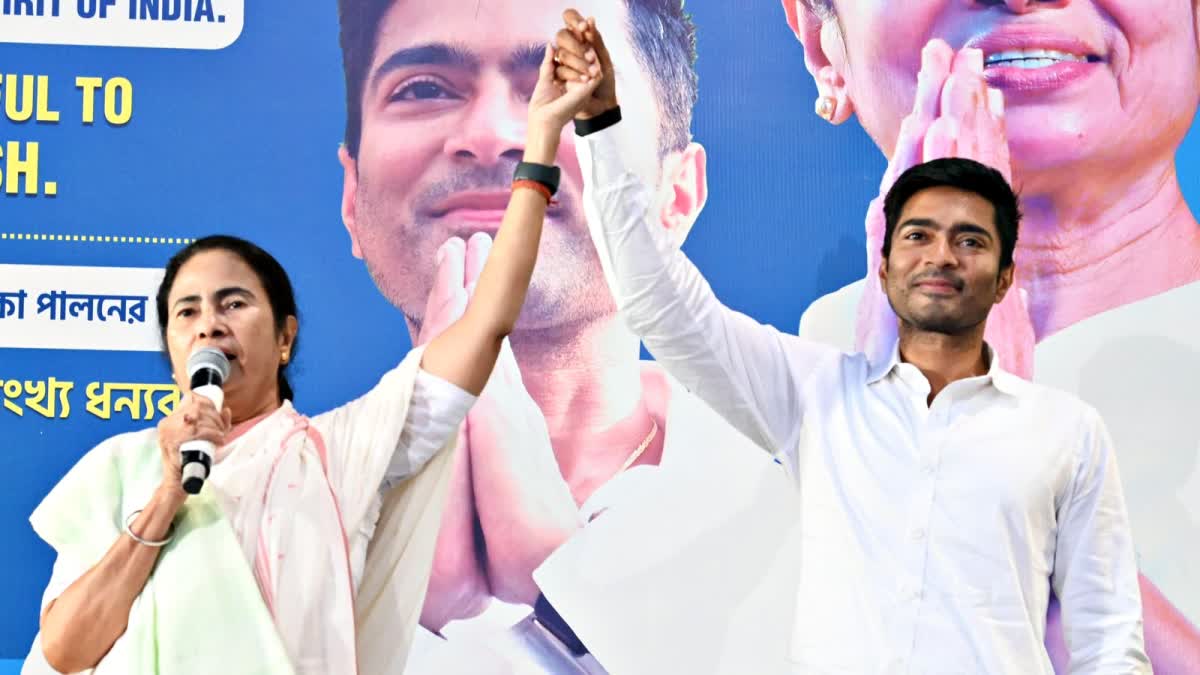 Mamata Banerjee holds hand of Abhishek Banerjee