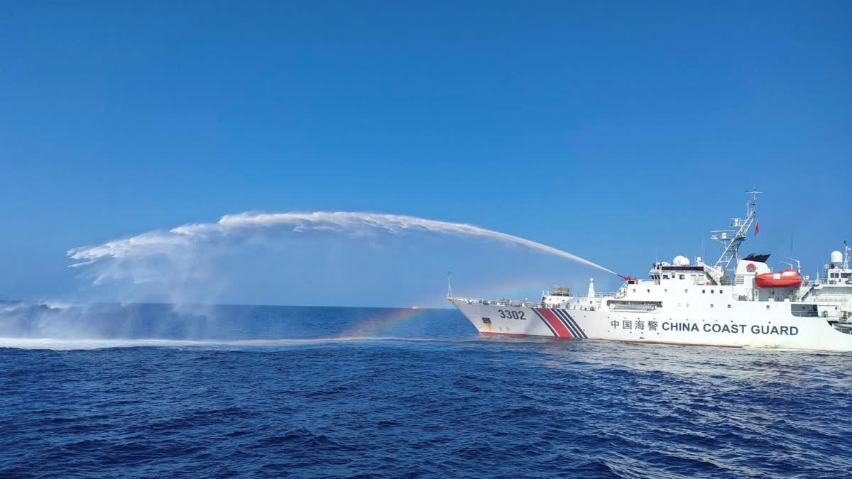 A Chinese Coast Guard ship, right, uses its water cannons on a Philippine Bureau of Fisheries and Aquatic Resources (BFAR) vessel, as it approaches Scarborough Shoal in the disputed South China Sea, Dec. 9, 2023.