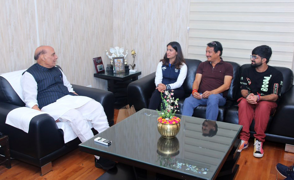 Manu Bhaker and her coach Jaspal Rana with defence Minister Rajnath Singh