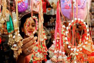 Women select 'Rakhi' kept for sale at a shop on the eve of 'Raksha Bandhan' festival, in Guwahati on Sunday.