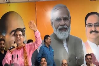 JK BJP President Ravinder Raina (L) addresses a party function in Jammu