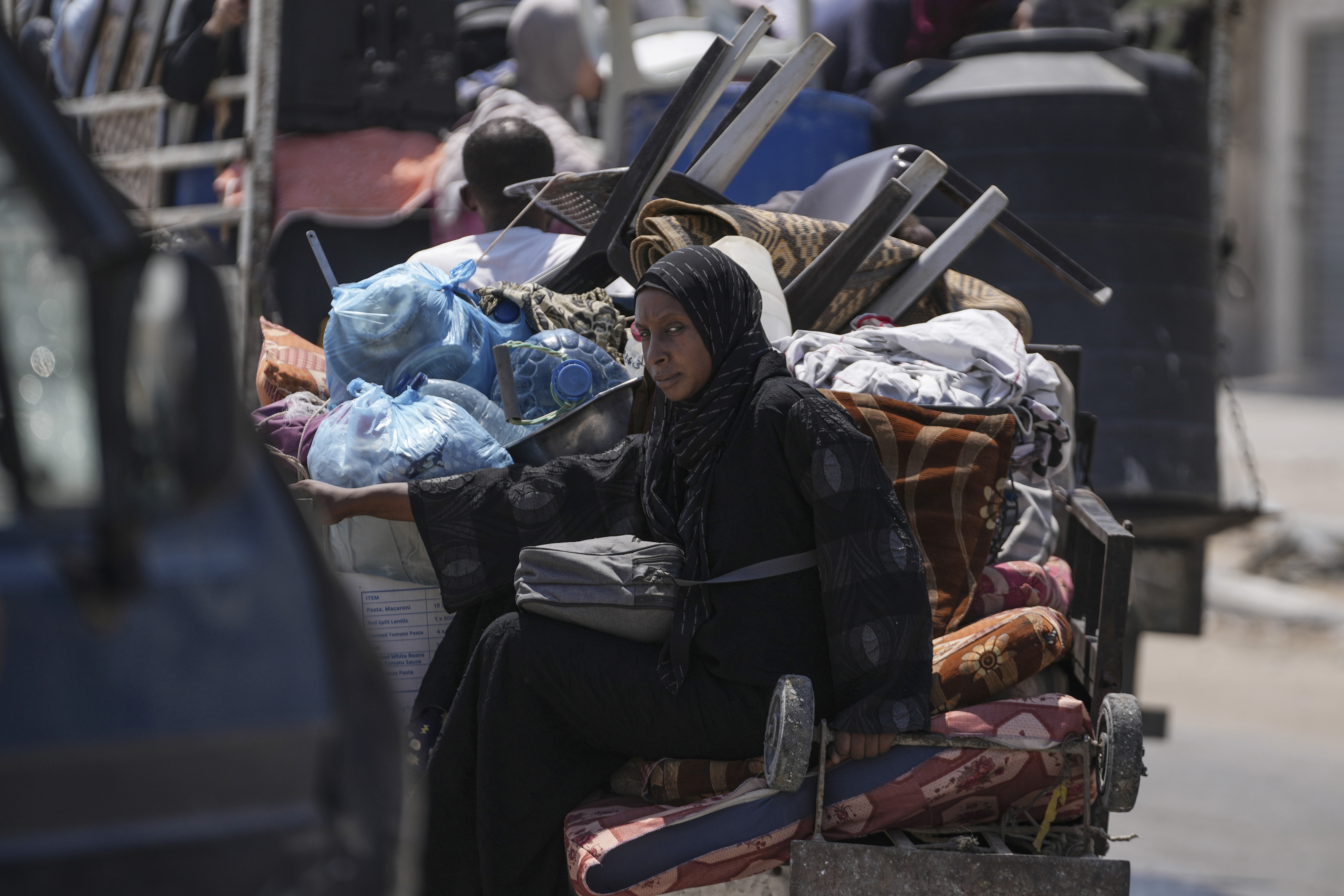 A Palestinian woman evacuates Maghazi refugee camp in the central Gaza Strip, as part of a mass evacuation ordered by the Israeli military ahead of an operation, Saturday, Aug. 17, 2024.