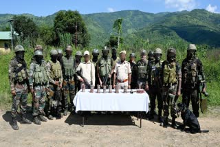 The joint team of security forces with the seized IEDs