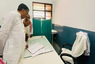 Samajwadi Party MP Rajeev Rai inspecting register during surprise visit of Mau District Hospital