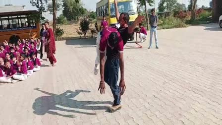 Demonstration of power by lifting a youth with teeth