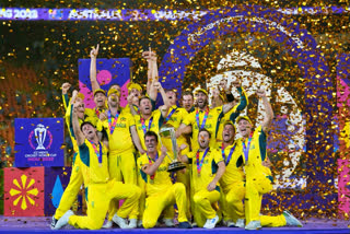 Australian players celebrate with the trophy after winning against India during the ICC Men's Cricket World Cup final match in Ahmedabad, India, Sunday, Nov.19, 2023. (AP Photo/Aijaz Rahi)