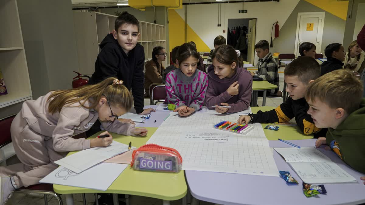 Children study in an underground school in Liubotyn, Kharkiv region, Ukraine, Monday Nov. 11, 2024.