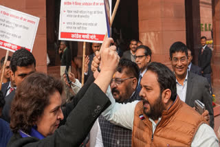 Congress MP Priyanka Gandhi Vadra and BJP MP Hemang Joshi with other INDIA bloc and NDA members during a protest in Parliament premises, in New Delhi, Thursday, Dec. 19, 2024.