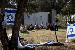 Jewish women sing together as they visit the site where hundreds of revelers were killed or captured by Hamas on Oct. 7, 2023 at the Nova music festival in Re'im, southern Israel, near the Israel-Gaza border, Friday, Jan. 19, 2024. (AP Photo/Maya Alleruzzo)