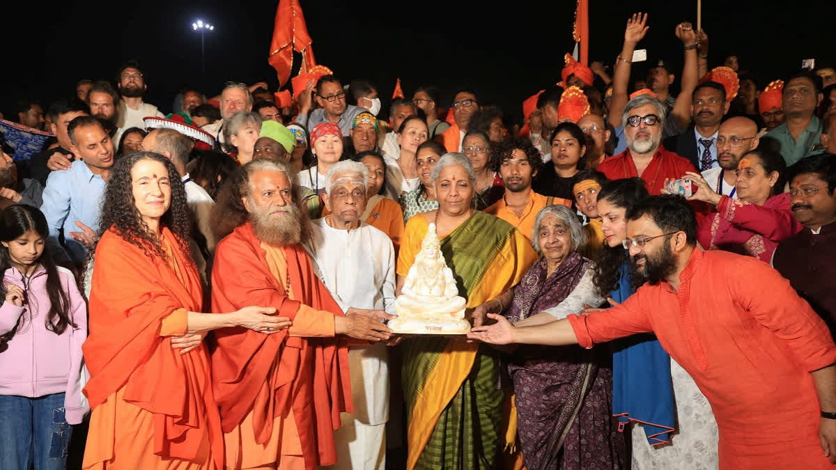 In this image posted by @ParmarthNiketan via X on Wednesday, Feb. 19, 2025, Union Finance Minister Nirmala Sitharaman with parents, spiritual leader and Parmarth Niketan President Swami Chidanand Saraswati and others during the ongoing Maha Kumbh Mela festival, in Prayagraj, Uttar Pradesh.