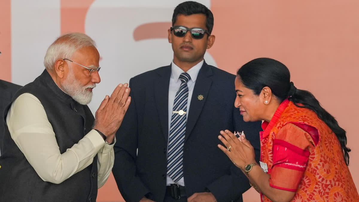 Prime Minister Narendra Modi exchanges greetings with newly sworn-in Delhi Chief Minister Rekha Gupta during a ceremony at Ramlila Maidan, in New Delhi, Thursday, Feb. 20, 2025.