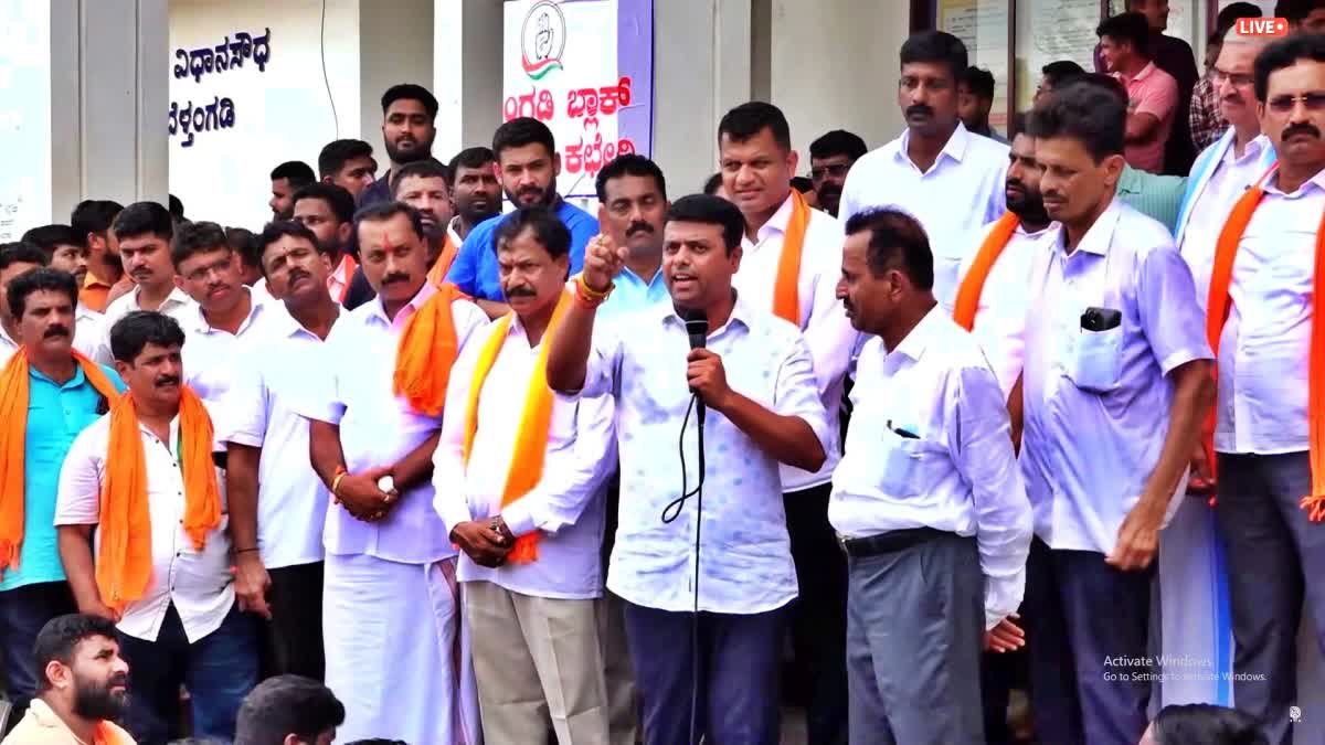 MLA Harish Poonja spoke during the protest.