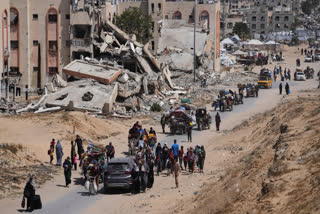 Displaced Palestinians flee from Khan Younis, Gaza, amid the ongoing Israeli military offensive in the area, on Monday, May 19, 2025.