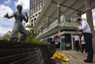 Bruce Lee's fans laid flowers at his statue at the Avenue of Stars on his 50th death anniversary on Thursday.