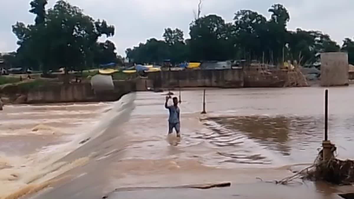 Young man crossing the Anicut of Kanhar river