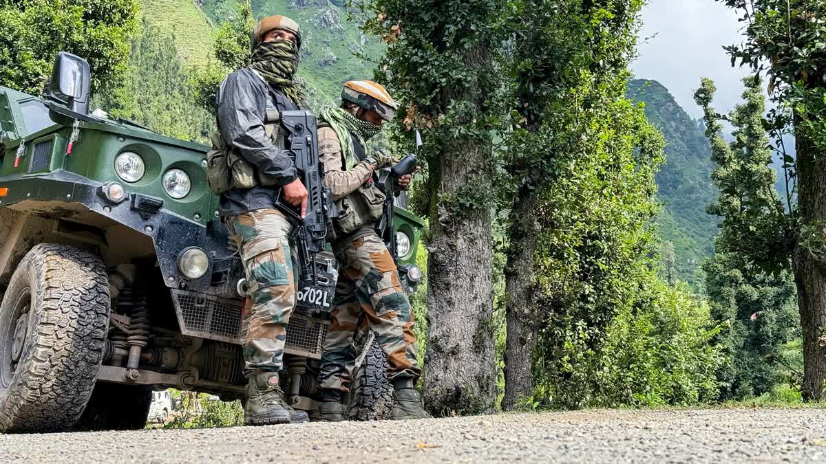 Security personnel stand guard during the search operation at Dudu to track militants, in Udhampur on Monday, Aug 19, 2024