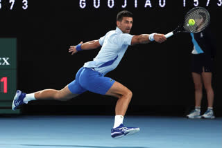 Novak Djokovic of Serbia plays a backhand return to Adrian Mannarino of France during their fourth round match at the Australian Open tennis championships