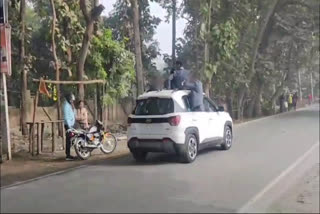 School kids perform stunts with car