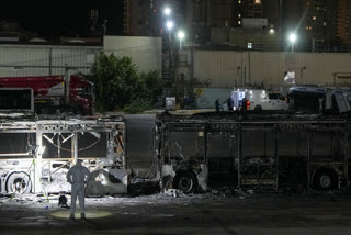 Israeli police inspect the scene of one of a series of bus explosions in what authorities said appeared to be a militant attack in Bat Yam, central Israel, Thursday, Feb. 20, 2025.