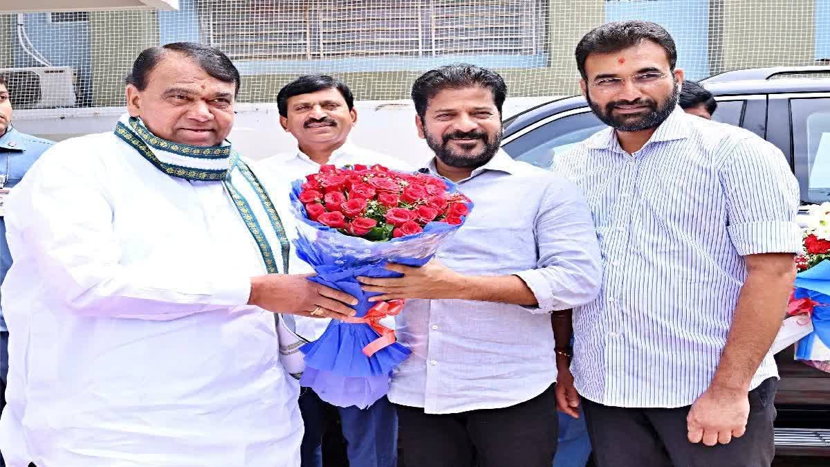 Chief Minister Revanth Reddy presents a bouquet to former Speaker and BRS MLA Pocharama Srinivas Reddy in Hyderabad inviting him into the party's fold