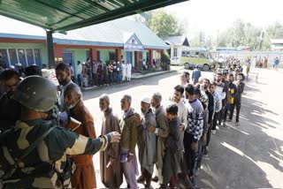 Voters queue up outside a polling station during Lok Sabha election 2024 in Kashmir