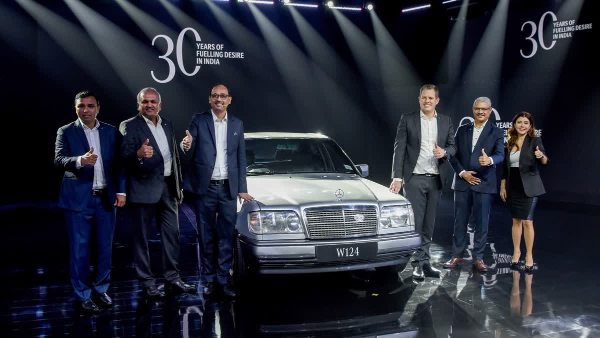 Mercedes-Benz India Chief Executive Officer (CEO), Managing Director Santosh Iyer with Mercedes-Benz India Vice President Sales and Marketing Lance Bennett and others pose for a picture with the first model by Mercedes-Benz in India (W124) during the launch of the Mercedes-Benz GLS facelift, in New Delhi