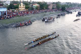 Devotees take part in a boat race on the occasion of Manasha Puja, at Bidyadhari River in North 24 Parganas in West Bengal