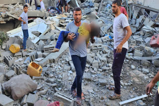 Israel continued to bomb Gaza killing at least 12 more people on Saturday as aid deliveries began moving into the besieged Strip, two weeks after the militant group Hamas rampaged through southern Israel and Israel responded with airstrikes, killing over 5,500 people on either end.