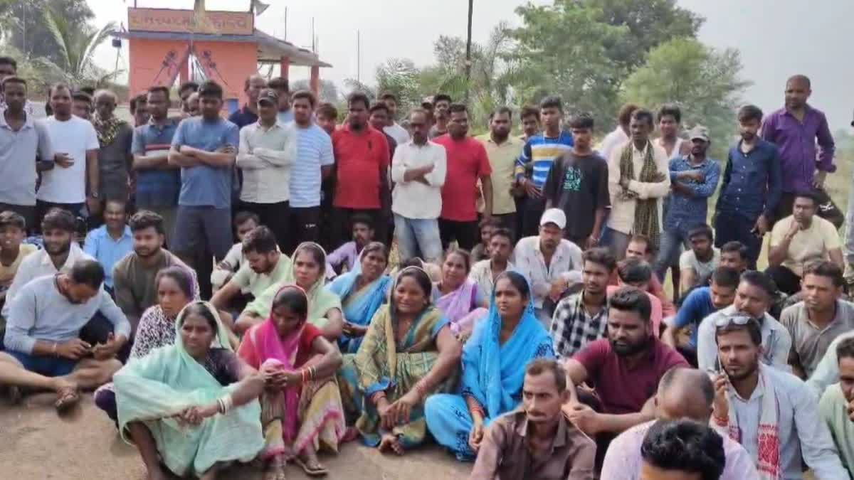 Family members of the victims sit on the highway in protest of reckless driving