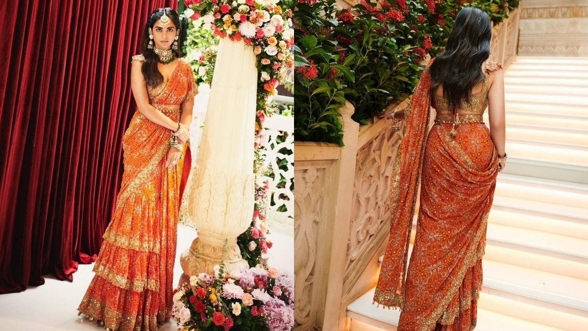 Isha Ambani looks stunning in this orange pre-draped ruffled saree