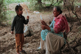 A woman playing with her grandson