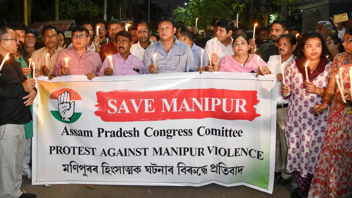 Activists of the Assam Pradesh Congress Committee (APCC) take out a candlelight procession during a protest against the ongoing violence in Manipur