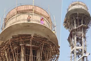 The family atop the water tank in Dausa