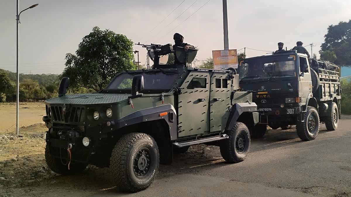 Security personnel conduct a search operation after two suspected terrorists seen by locals in the Hiranagar area of Kathua