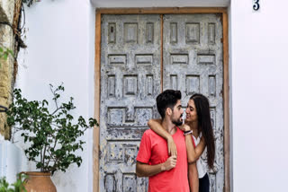 Couple standing against a door