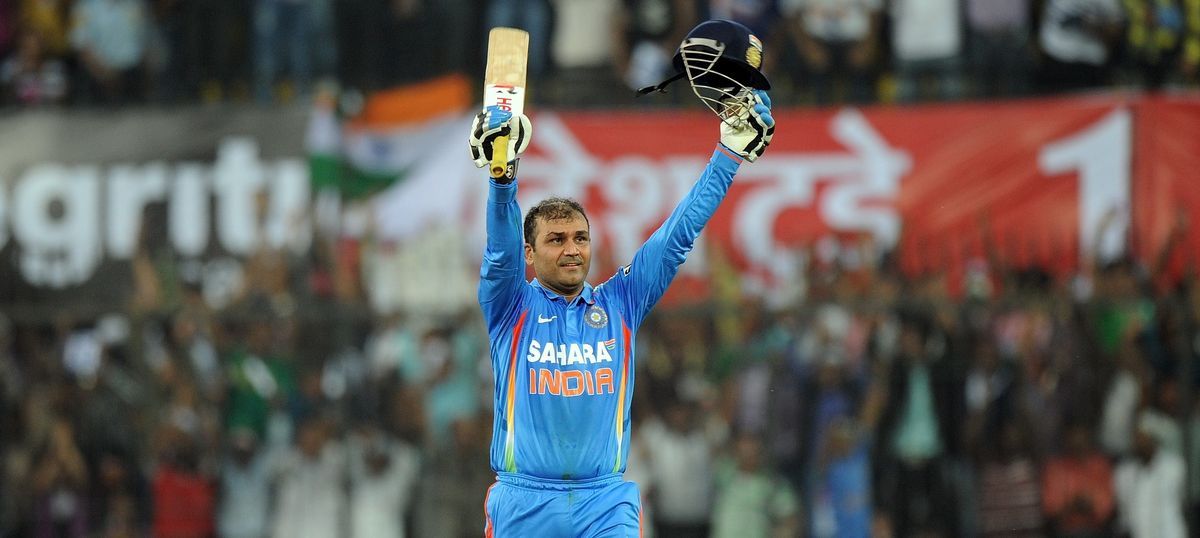 Virender Sehwag raises his bat after scoring his maiden ODI double ton against Windies in 2012 in Indore.