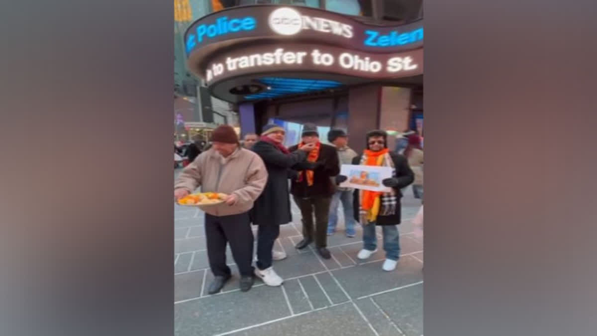 Members of overseas Friends of Ram Mandir distributing laddoos at Times Square